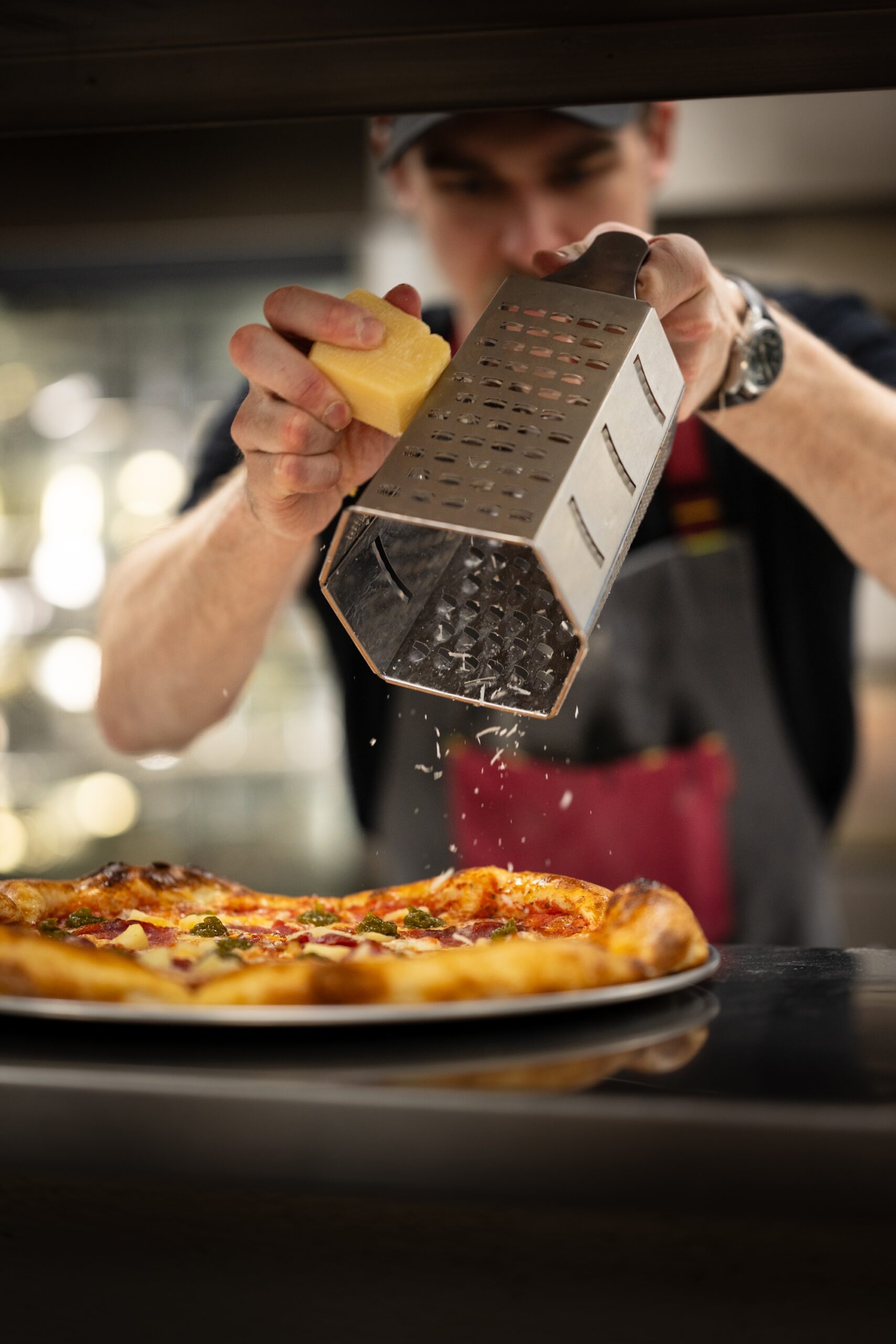 Brewco team members making pizzas in the kitchen
