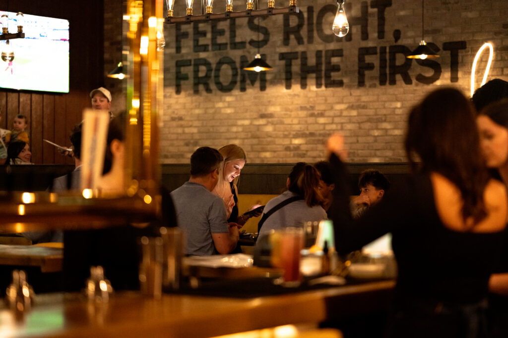 Guests enjoying food and drinks at Brewco